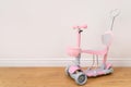 Pink toddler scooter for a baby. Summertime activity for kids. Royalty Free Stock Photo