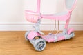 Pink toddler scooter for a baby. Summertime activity for kids. Royalty Free Stock Photo