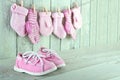 Pink toddler shoes on wooden light green background