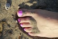Pink toes resting on the beach Royalty Free Stock Photo