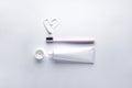 Pink toothbrush and tube of toothpaste on a white background Royalty Free Stock Photo