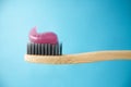 Pink toothpaste on a natural bamboo toothbrush Royalty Free Stock Photo