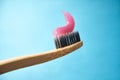 Pink toothpaste on a natural bamboo toothbrush Royalty Free Stock Photo