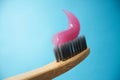 Pink toothpaste on a natural bamboo toothbrush Royalty Free Stock Photo