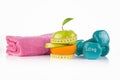 Pink towel, green apple with measuring tape with a pair of blue fitness dumbbells and protein drink Royalty Free Stock Photo