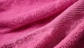 A pink towel with a textured surface