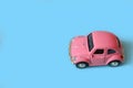 Pink toy car on a blue background Royalty Free Stock Photo