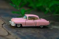 Pink toy car out for a ride Royalty Free Stock Photo