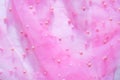 Pink translucent fabric embroidered with beads. Get a red carpet