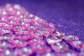 Pink transparent plastic hearts on purple glittering background Royalty Free Stock Photo