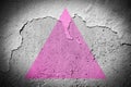 Pink triangle flag on cracked wall