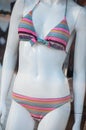 pink tripped bikini on mannequin in fashion store showroom for women