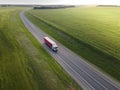 Pink Truck with Cargo Semi Trailer Moving on Road in Direction. Highway intersection junction. Aerial Top View Royalty Free Stock Photo