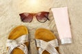 pink tube cream, and sunglasses, slippers. summer beach concept.