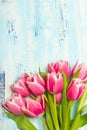 Pink tulip bouquet on blue wooden background, copy space Royalty Free Stock Photo