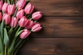 Pink tulip bunch on rustic barn wood planks, perfect for text