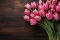 Pink tulip bunch with space for text on dark barn wood