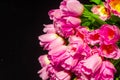 Pink tulips on black background. Flat lay, top view. Valentines background. Bouquet of pink tulips on a light background