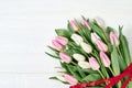 Pink tulips bouquet decorated with hearts ribbon. Copy space Royalty Free Stock Photo