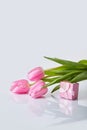 Pink tulips bouquet with gift box on a table Royalty Free Stock Photo