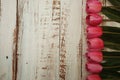 Pink Tulips bouquet with Space for text on a wooden background