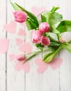 Pink tulips bouquet in vase on white wooden table Royalty Free Stock Photo