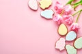 Pink tulips with easter gingerbread eggs located in a row on pink background. Floral pattern. Mock up and banner. Space for text Royalty Free Stock Photo