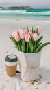 Pink tulips in a flowerpot sit next to a cup of coffee on the beach Royalty Free Stock Photo