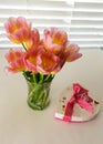 Pink tulips in full bloom in vase with Valentine candy box beside it on table Royalty Free Stock Photo