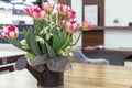 Pink tulips in metal flowerpot on a wooden table Royalty Free Stock Photo