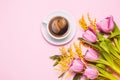 Pink tulips and mimosa flowers with cup of coffee on pink background. Royalty Free Stock Photo