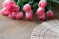 Pink tulips with open hand fan. Wooden board. Tulip. Vintage an Royalty Free Stock Photo