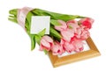 Pink tulips with satin ribbon on the wooden frame with postcard Royalty Free Stock Photo