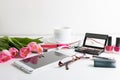 Pink tulips, tablet, cosmetics, wristwatch, notepad