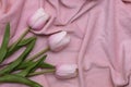 Pink tulips on a pink velor fabric. Background for design with place for text. The photo