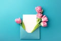 Pink tulips and white card in envelope. Royalty Free Stock Photo