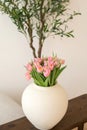 Pink tulips in white vase on wooden table Royalty Free Stock Photo