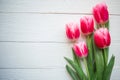 Pink tulips on wooden background. Flat lay, top view, copy space. Royalty Free Stock Photo