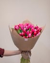 Woman holding pink tulpan flower bouquet