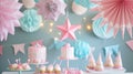 Pink and turquoise party decorations with cake and cupcakes on a table