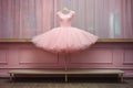 pink tutu hanging on a ballet barre
