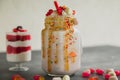 Pink unicorn milkshake with whipped cream and sweet dessert, dripping sauce and candy Royalty Free Stock Photo