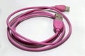 Pink used USB plug with cable on the white background. Royalty Free Stock Photo