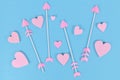 Pink Valentine`s day cupid`s arrows with heart shaped tips and heart ornaments Royalty Free Stock Photo