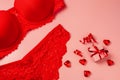 Pink Valentine's Day background with beautiful female lacy panties, bra, hearts and gift box. Sexy underwear. Free space Royalty Free Stock Photo
