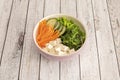 Pink vegan bowl with wakame seaweed salad with diced white tofu, grated carrot, cucumber slices and edamame beans Royalty Free Stock Photo