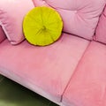 Pink velvet sofa with fancy green cushion