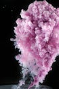 Pink vertical cloud of paint in water on a dark background