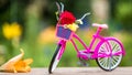 Pink vintage bicycle with basket and flowers leaning against wooden fence at the garden Royalty Free Stock Photo