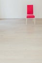 Pink vintage chair in the interior of an empty white room Royalty Free Stock Photo